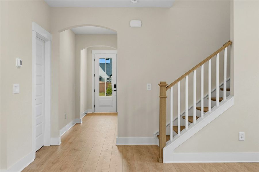 An inviting entrance foyer welcomes guests with wa