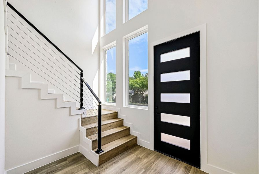 Entryway with stairs and light wood-style flooring