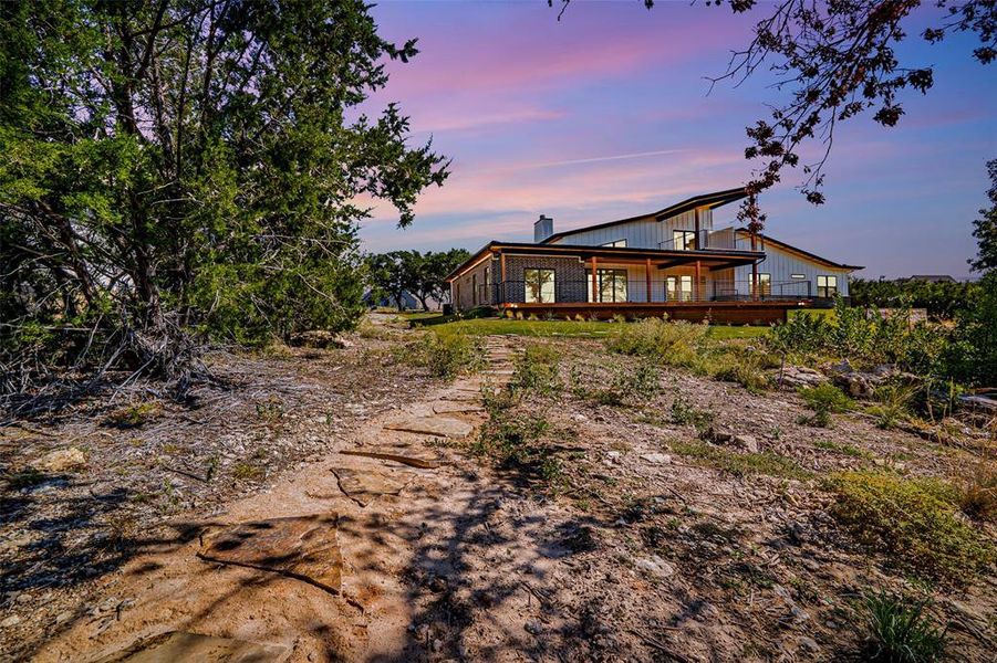 Back of house at dusk featuring a chimney Back of house at dusk featuring a chimney