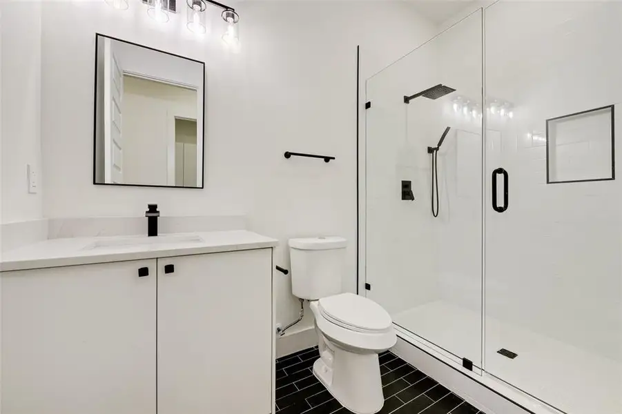 Bathroom with vanity and a stall shower Bathroom with vanity and a stall shower