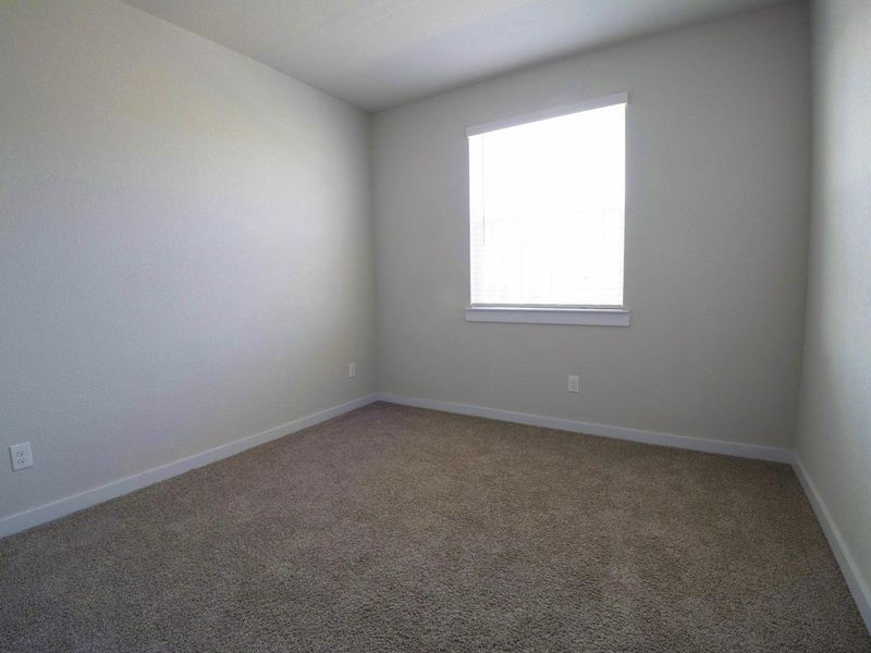 Unfurnished room with carpet and baseboards Unfurnished room with carpet and baseboards