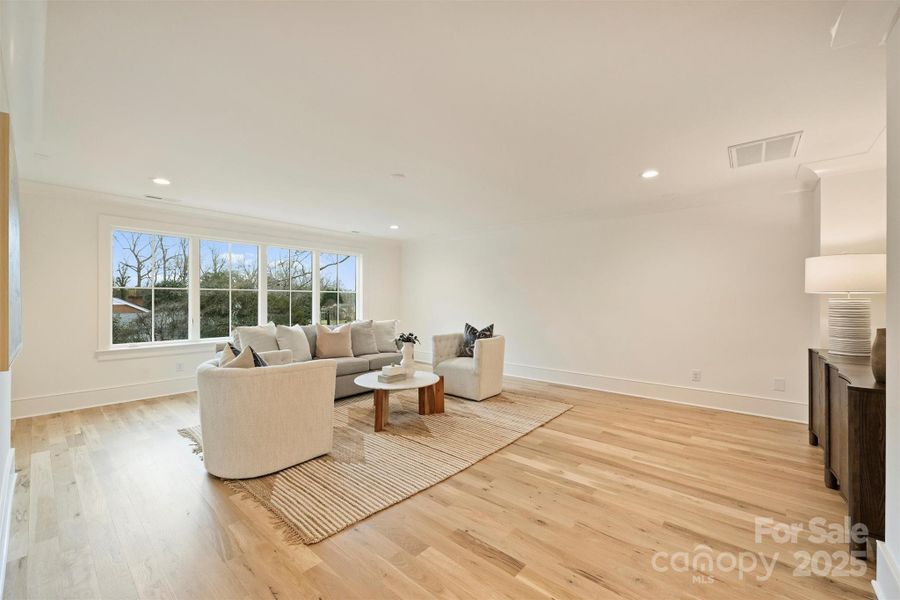 On the second level, a spacious bonus room provides an inviting additional space for lounging.