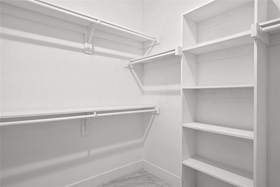 Spacious closet with light marble finish floors Spacious closet with light marble finish floors