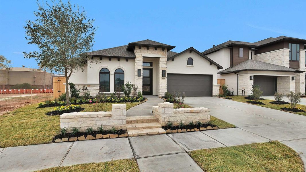 Front exterior of a new home in Sienna, Missouri City, TX, highlighting curb appeal (Image 2). Front exterior of a new home in Sienna, Missouri City, TX, highlighting curb appeal (Image 2).