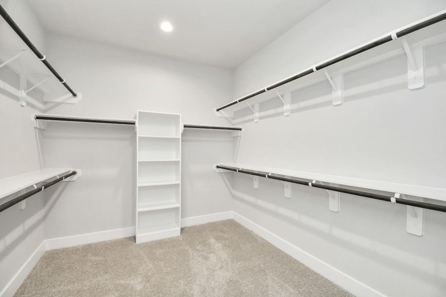 Walk-in closet that epitomizes luxury and practicality. This generously sized space features built-in shelving, offering abundant room for impeccable organization. High ceilings and recessed lighting create a bright and welcoming ambiance. Walk-in closet that epitomizes luxury and practicality. This generously sized space features built-in shelving, offering abundant room for impeccable organization. High ceilings and recessed lighting create a bright and welcoming ambiance.