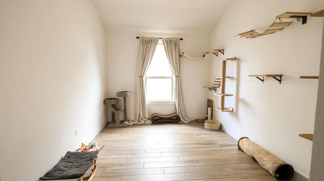 Natural light illuminates this versatile room with durable tile flooring and wall-mounted shelves. Natural light illuminates this versatile room with durable tile flooring and wall-mounted shelves.