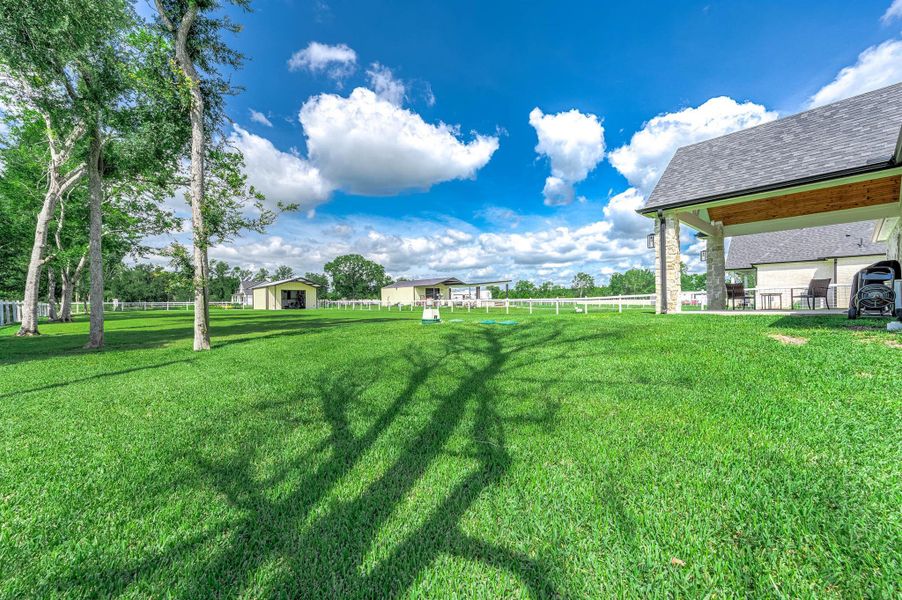 The property offers an expansive backyard with plenty of open green space, mature trees, and room to enjoy outdoor living. Additional structures provide excellent flexibility for storage, workspace, hobbies, or recreational use while enhancing the functionality of the property.