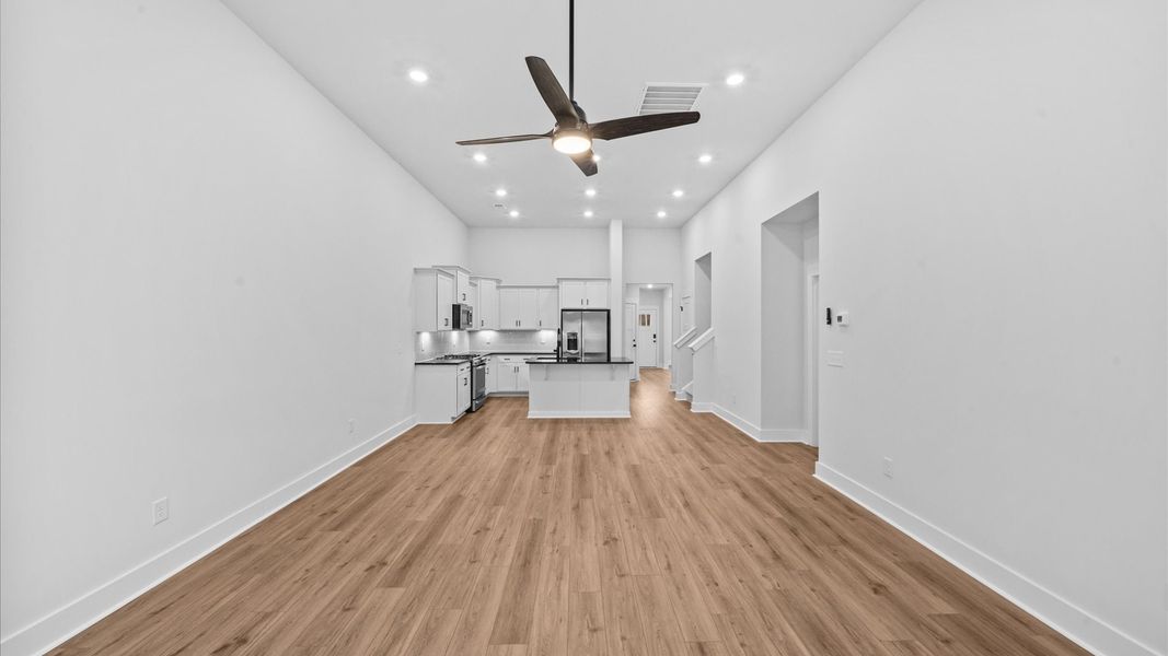 Tasteful family room with two-story volume, refined finishes, and exceptional natural light Tasteful family room with two-story volume, refined finishes, and exceptional natural light