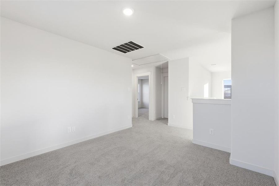 Carpeted room with white walls, recessed ceiling lighting, and a white baseboard trim Carpeted room with white walls, recessed ceiling lighting, and a white baseboard trim