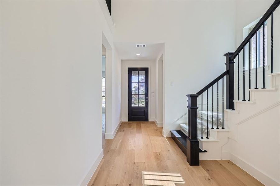 Foyer with light hardwood / wood-style floors