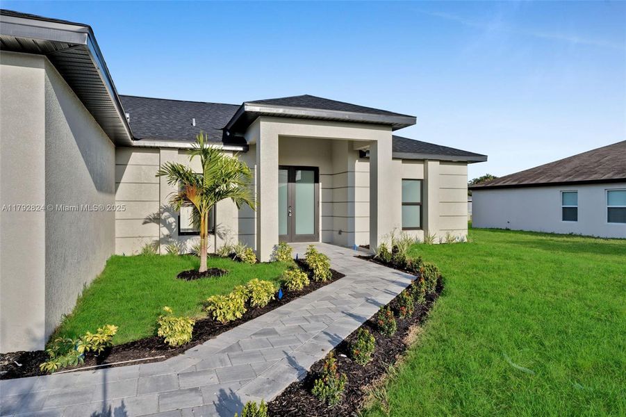 Front exterior of a new home in , Cape Coral, FL, highlighting curb appeal (Image 1). Front exterior of a new home in , Cape Coral, FL, highlighting curb appeal (Image 1).