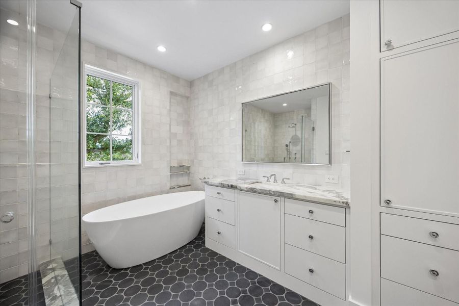 Primary Bathroom with soaking tub and nero limestone mosaic floors Primary Bathroom with soaking tub and nero limestone mosaic floors