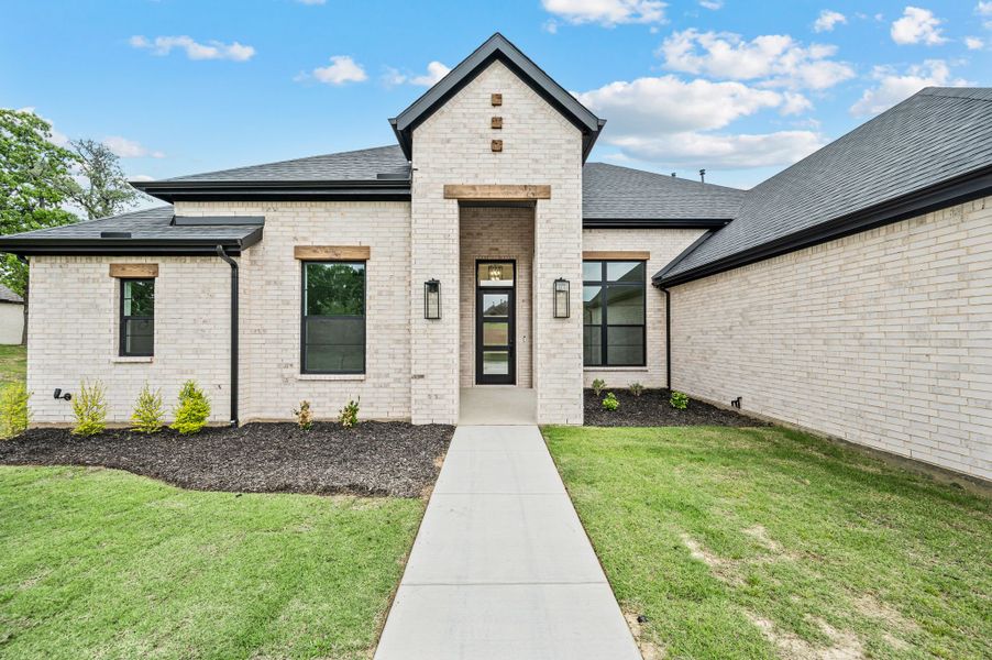 Front exterior of a new home in Highland Oaks, Boyd, TX, highlighting curb appeal (Image 28). Front exterior of a new home in Highland Oaks, Boyd, TX, highlighting curb appeal (Image 28).