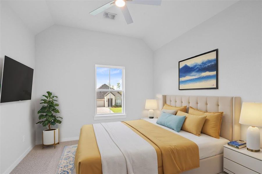 Secondary bedroom features plush carpet, custom paint, ceiling fan with lighting and a large window with privacy blinds.