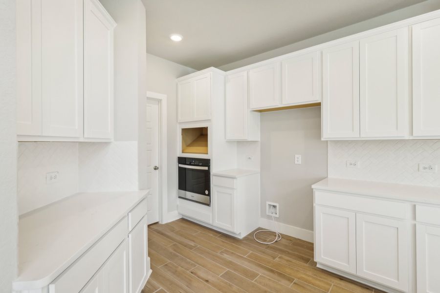 Kitchen in the Cedar floorplan at a Meritage Homes community.