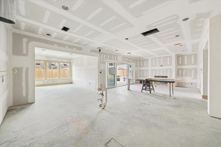 Spacious living and dining areas flow effortlessly to oversized sliding glass doors opening to the covered patio and outdoor kitchen. Recessed lighting and expansive rear windows bring architectural detail and natural light to this Oak Forest new construction.