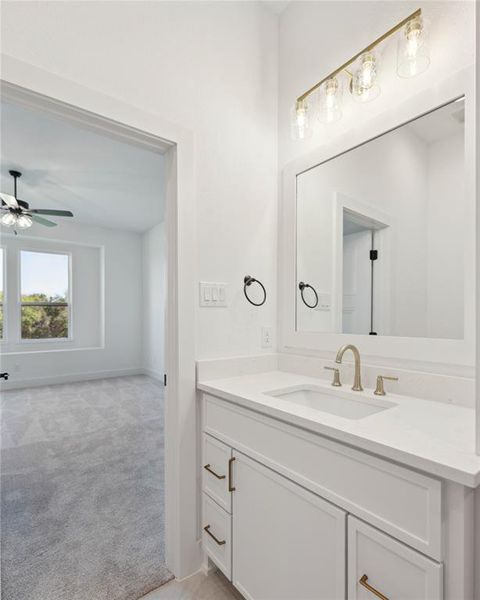 Bathroom with ceiling fan and vanity