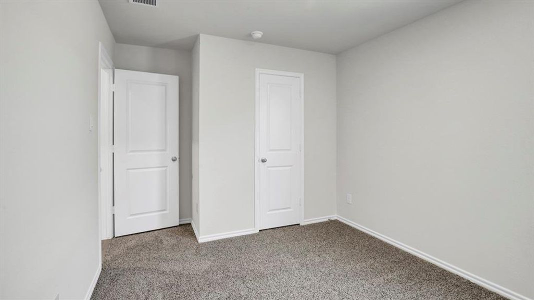 Unfurnished bedroom featuring carpet flooring and baseboards