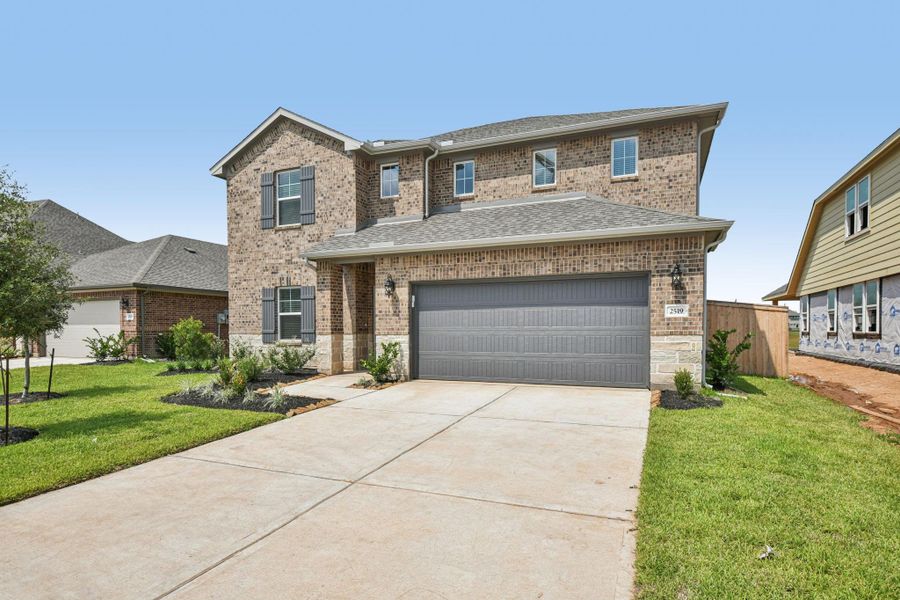 Front exterior of a new home in Kingdom Heights, Rosenberg, TX, highlighting curb appeal (Image 2).