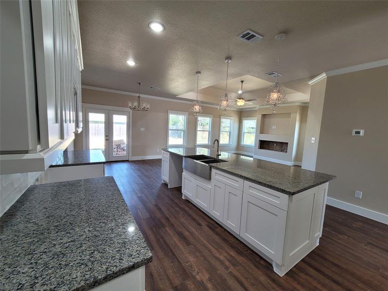 Kitchen featuring dark hardwood / wood-style floors, sink, and a spacious island