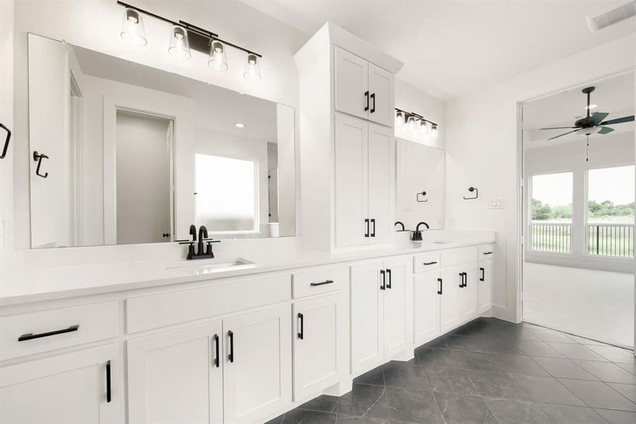 Dual vanity with white cabinetry, matte black hardware, and quartz countertops