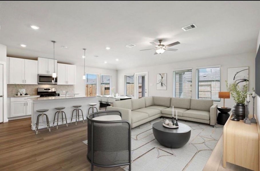 This room has been virtually staged to showcase its spacious open layout and potential furniture placement. The virtual staging highlights the bright living area, seamless flow into the kitchen, and the versatility of the space for modern living.