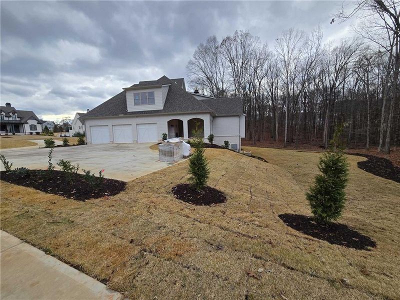 Front exterior of a new home in , Flowery Branch, GA, highlighting curb appeal (Image 7).