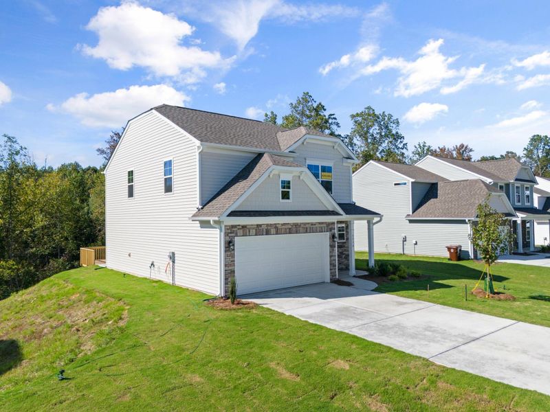 Front exterior of a new home in Cottages at Piper Village, Trinity, NC, highlighting curb appeal (Image 18).