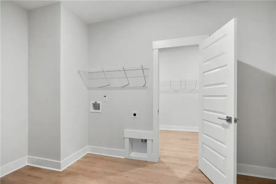 A well-appointed laundry room with convenient shel A well-appointed laundry room with convenient shel