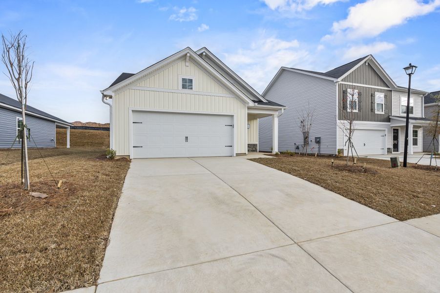 Front exterior of a new home in Canary Woods, Hopkins, SC, highlighting curb appeal (Image 19). Front exterior of a new home in Canary Woods, Hopkins, SC, highlighting curb appeal (Image 19).