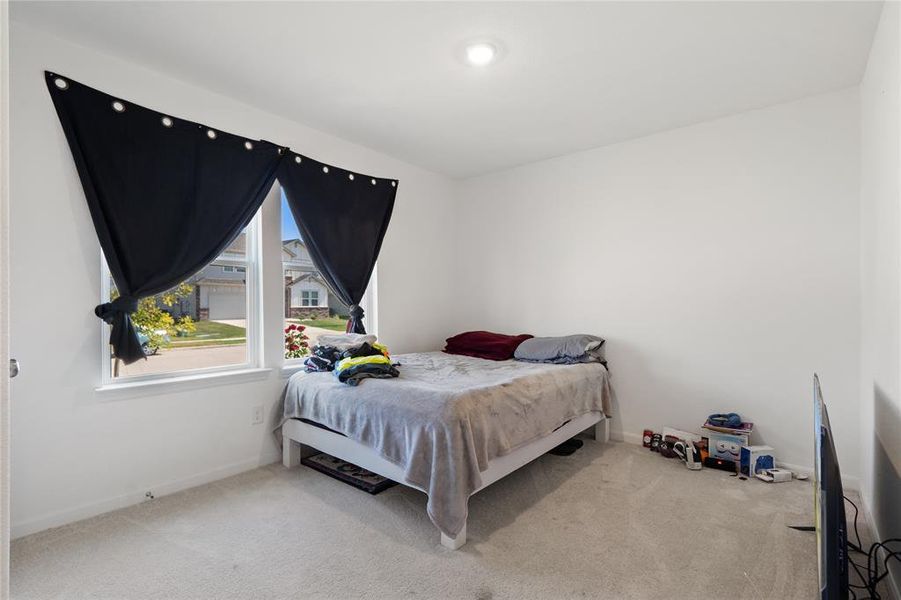 Bedroom featuring light colored carpet