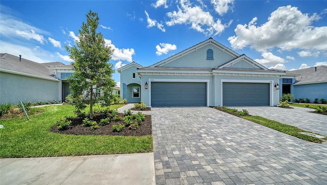 Front exterior of a new home in Windward, Lakewood Ranch, FL, highlighting curb appeal (Image 2).