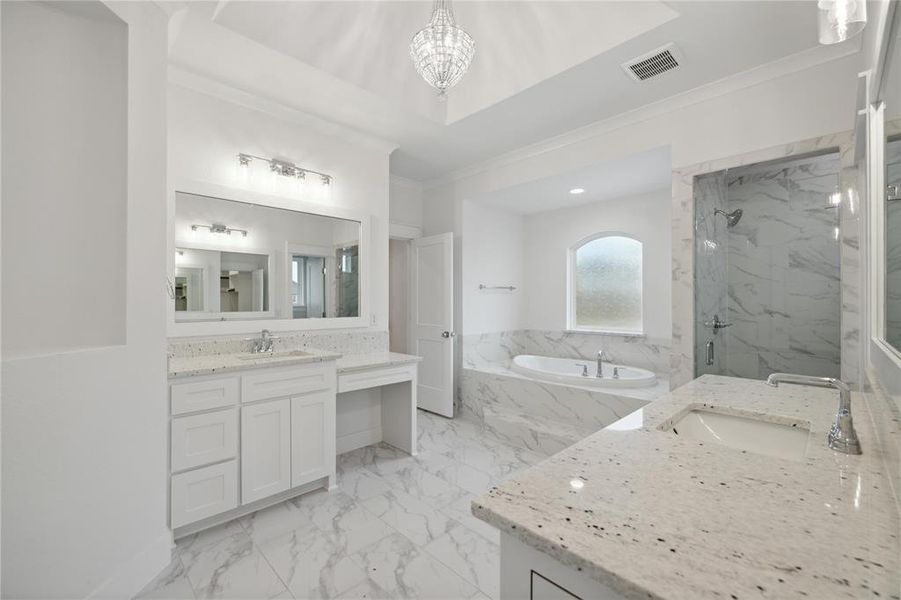 Bathroom featuring vanity, tile patterned floors, independent shower and bath, ornamental molding, and an inviting chandelier