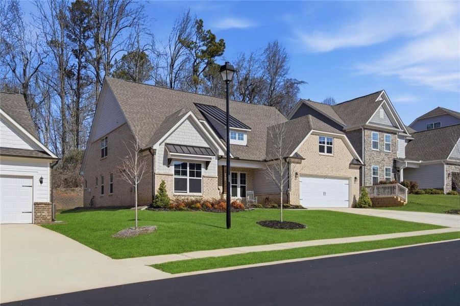 Front exterior of a new home in Cambridge, Flowery Branch, GA, highlighting curb appeal (Image 27). Front exterior of a new home in Cambridge, Flowery Branch, GA, highlighting curb appeal (Image 27).