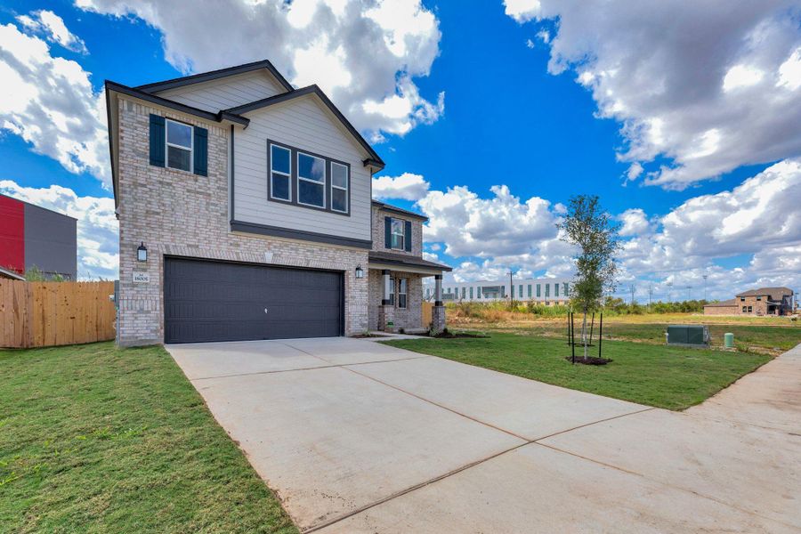 Front exterior of a new home in Mustang Valley, Manor, TX, highlighting curb appeal (Image 25).