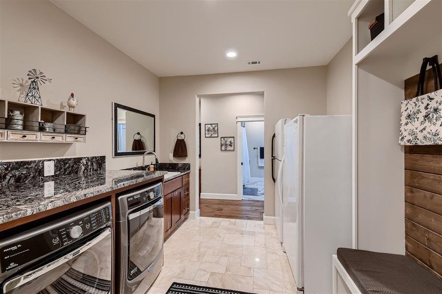 The laundry room features enough room for your second refrigerator & freezer.