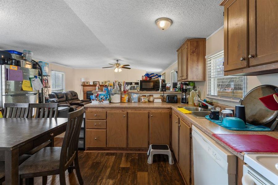 Kitchen with a wealth of natural light, dishwasher, open floor plan, and black microwave Kitchen with a wealth of natural light, dishwasher, open floor plan, and black microwave