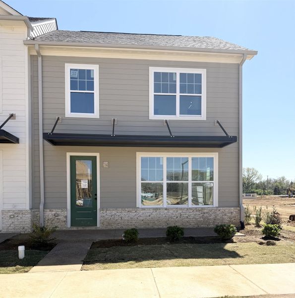 View of front of house featuring a shingled roof