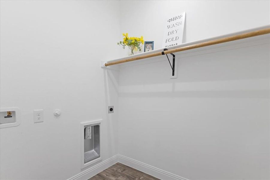 Laundry area with baseboards, dark wood finished floors, hookup for a gas dryer, hookup for a washing machine, and electric dryer hookup