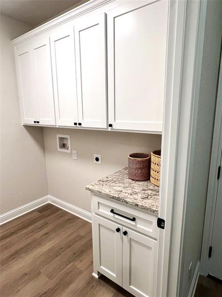 Laundry room with washer hookup, hookup for an electric dryer, cabinet space, dark wood-style floors, and baseboards Laundry room with washer hookup, hookup for an electric dryer, cabinet space, dark wood-style floors, and baseboards