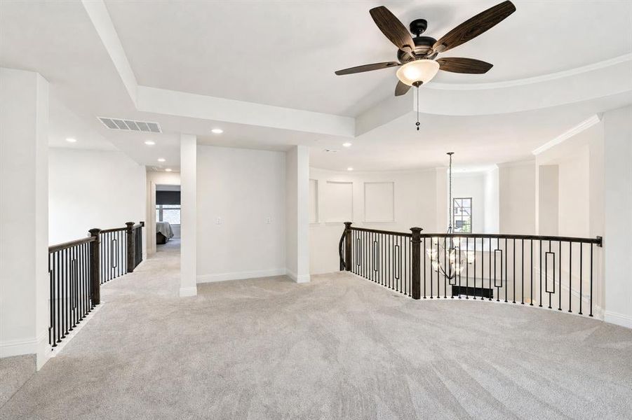 Upstairs is the game room that overlooks both the entry and living room.