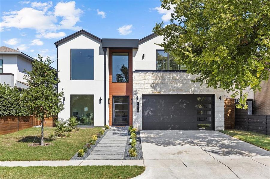 Contemporary house with a front yard and a garage