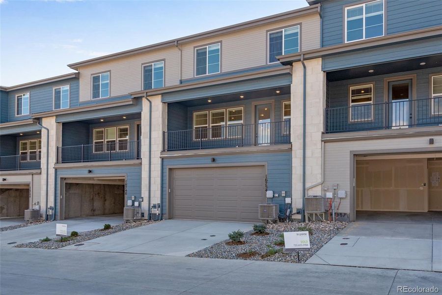 Front exterior of a new home in , Arvada, CO, highlighting curb appeal (Image 1).