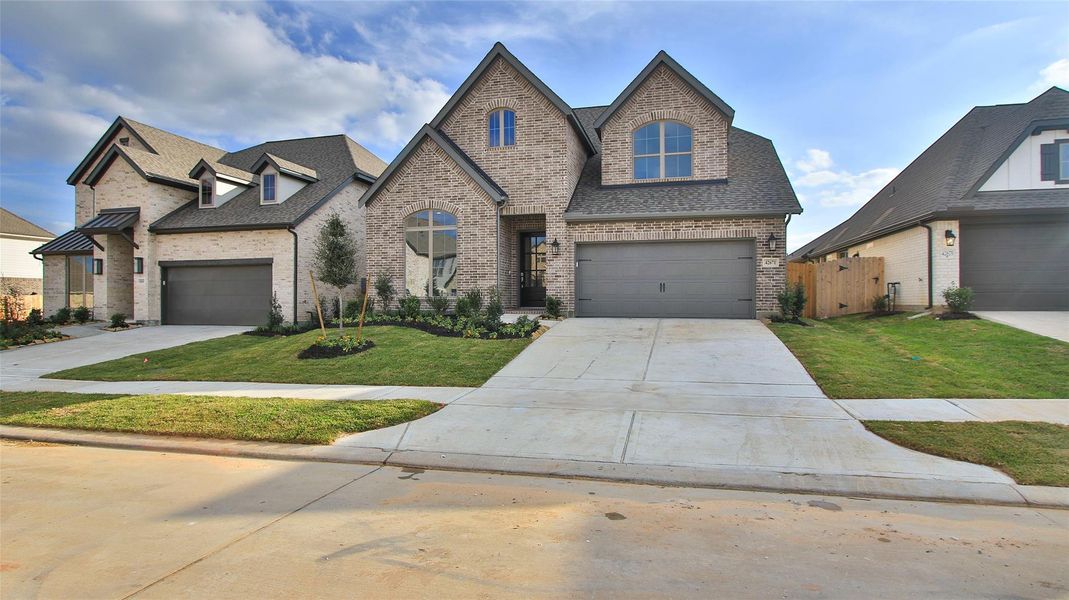 Front exterior of a new home in Escondido 50', Magnolia, TX, highlighting curb appeal (Image 2).