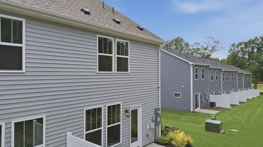 Rear backyard creates a seamless extension of this home’s elegant design at Clarke Townes