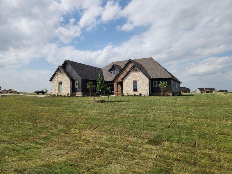 Expansive front yard featuring new sod