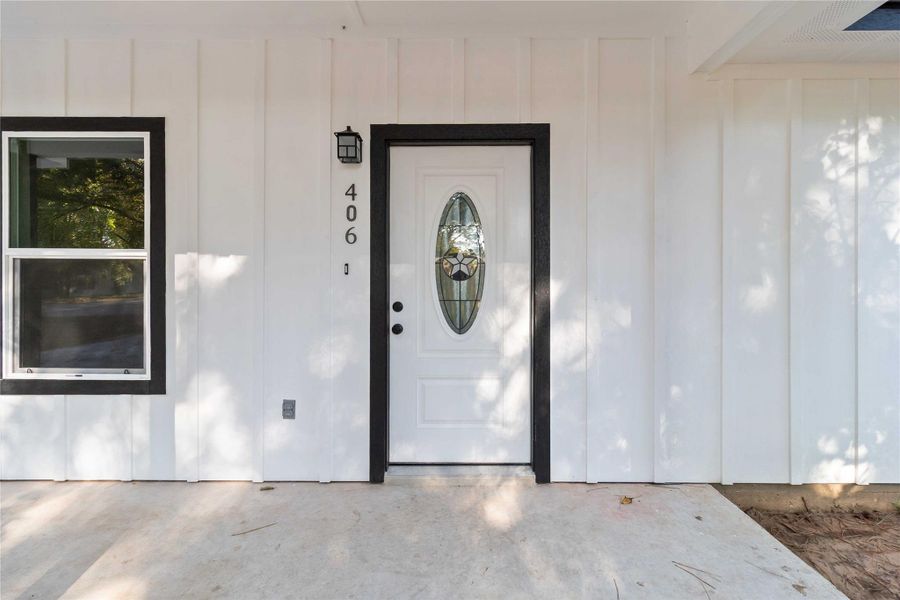 Doorway to property with board and batten siding
