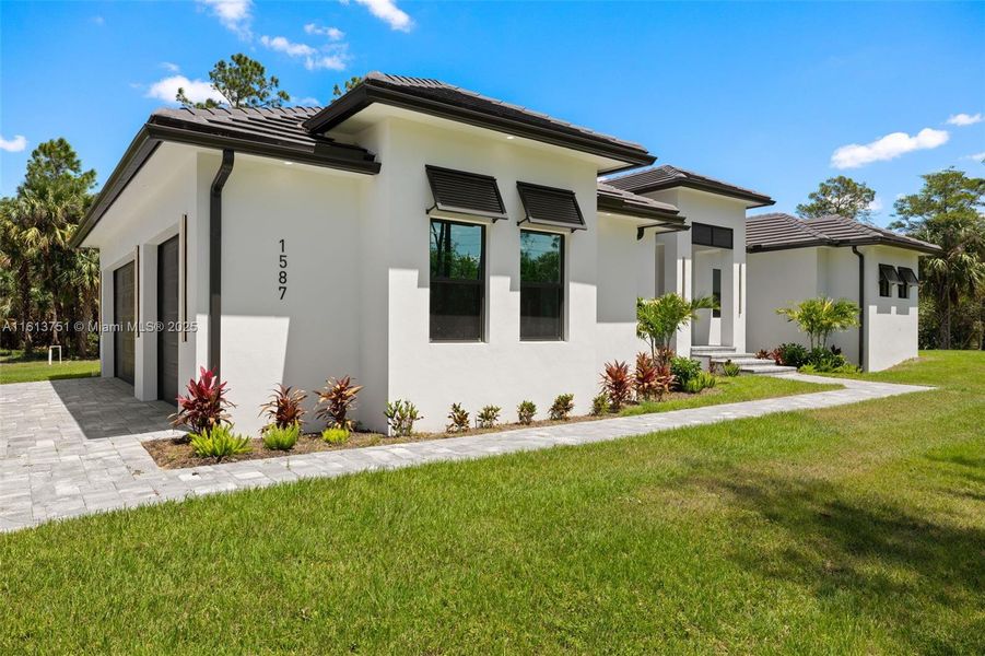 Front exterior of a new home in , Naples, FL, highlighting curb appeal (Image 1).