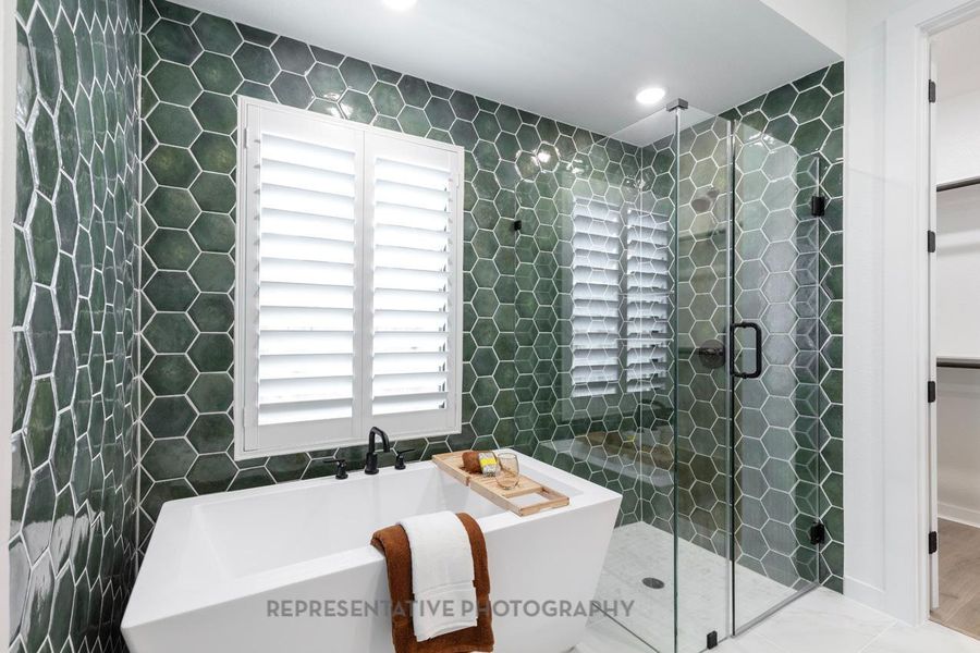 Bathroom featuring a freestanding bath, a shower stall, and tile walls Bathroom featuring a freestanding bath, a shower stall, and tile walls