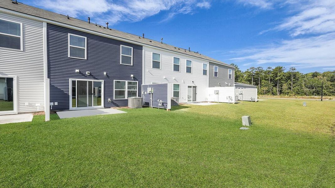 Exterior details and patio area of a home in Pine Hills Townhomes at Cane Bay, Summerville (Image 17).